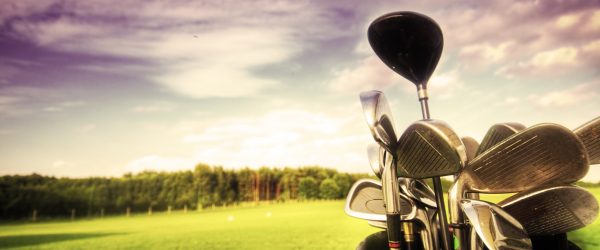 Professional golf gear on the golf field at sunset.